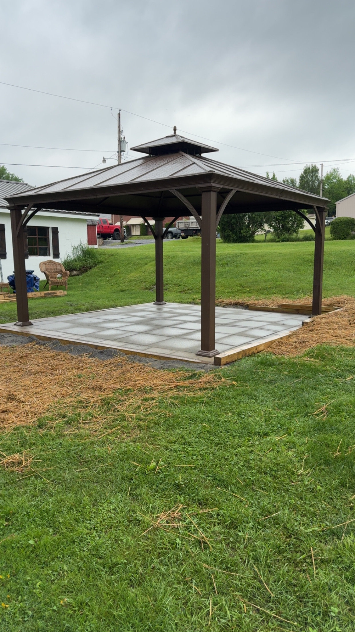 Wooden gazebo on a new paver pad set into a lawn in central Pennsylvania